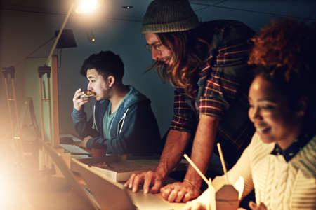 Working late without the fuss. young employees working late into the evening.