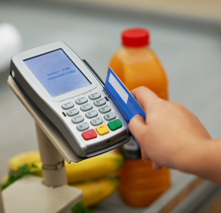 Ready for transaction. Closeup shot of a credit card payment being made in a grocery store.