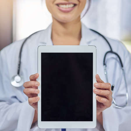 Improving the ways in which you receive healthcare. Closeup shot of a medical practitioner holding up a digital tablet.の写真素材