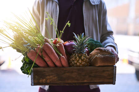Bringing the grocery store to you. a courier making a grocery delivery.の写真素材