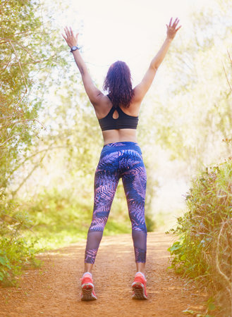 Outdoor workouts is the way forward. a sporty young woman outdoors.の写真素材