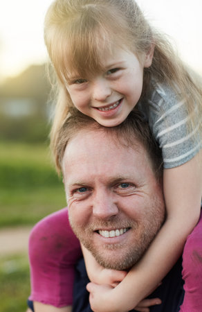 Daddys little darling. Cropped portrait of a little girl and her father standing outside.の写真素材