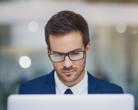 Fully focused. a young businessman working in his office.の写真素材
