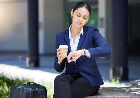 Time, travel and schedule with business woman looking at watch fo deadline, check the hour for traveling, an appointment or meeting. Discipline, timing and city entrepreneur to start the dayの写真素材
