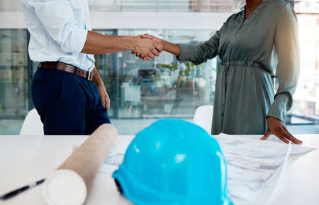 Architecture, shaking hands and a thank you handshake by engineer with a successful business...