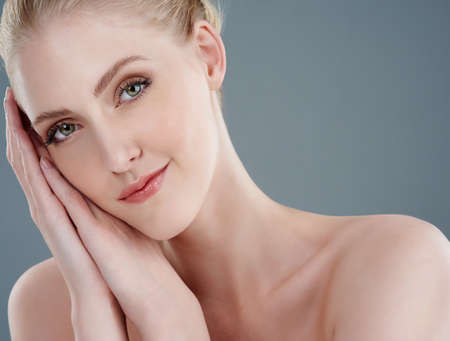 Fresh faced beauty Shes got it. Studio portrait of a young woman with beautiful skin isolated on gray.の写真素材