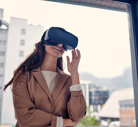 Go beyond what is seen in your dreams. a young businesswoman wearing a VR headset in an office.