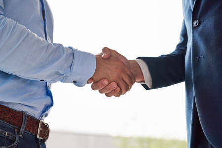 Theyve reached an agreement. Closeup shot of two businessmen shaking hands in an office.