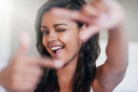 This is my cover girl look. Portrait of a happy young woman posing at home.