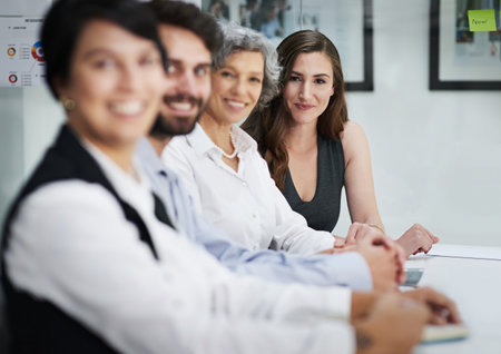 Were the team carrying this business forward. Portrait of a group of businesspeople sitting together...