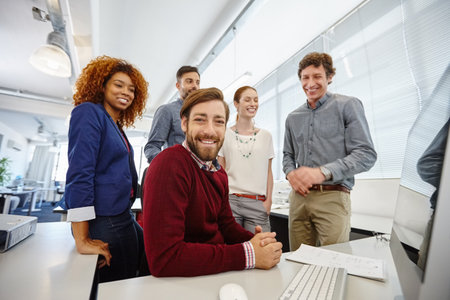 Job satisfaction is a great motivator. Portrait of a group of businesspeople having a meeting in their office.の写真素材