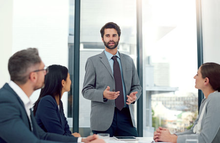 Impressing the team with his brilliant solutions. a businessman giving a presentation to his...