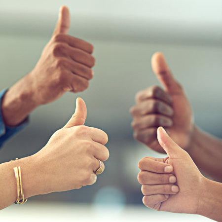 That was amazing. Closeup shot of a group of businesspeople giving thumbs up together.の写真素材
