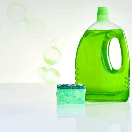 For squeaky clean surfaces. Studio shot of a bottle of dishwashing detergent and a sponge against a...