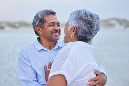 Senior, love and couple hug in nature at lake or beach on retirement holiday with a smile looking...
