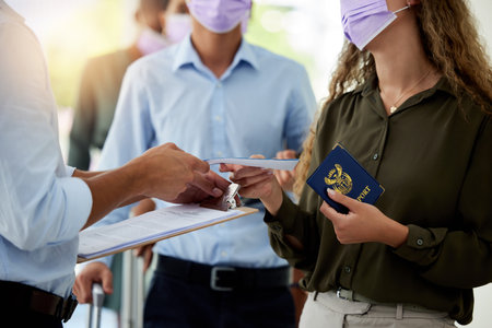 Covid, passport and travel with airport security reading ticket of a passenger or woman refugee for...