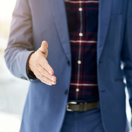 Allow me to welcome you...Closeup shot of a businessman gesturing for a handshake.の写真素材