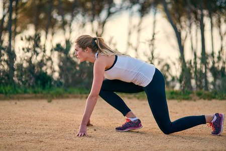 On your marks. an attractive young woman exercising outdoors.の写真素材