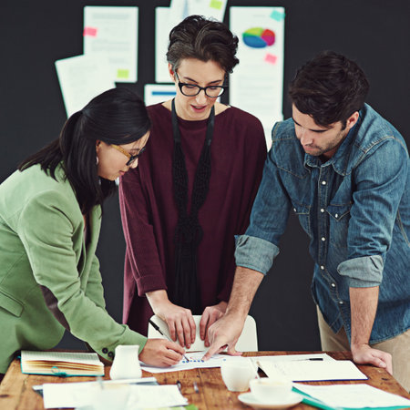 We could definitely make some improvements to this. a group of young creatives having a meeting in a modern office.の写真素材
