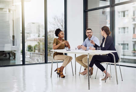 Brainstorming for ideas for their project. a group of businesspeople having a meeting in a modern...