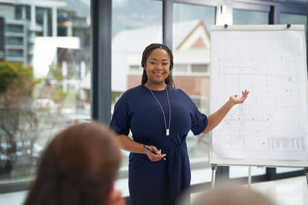 That couldnt have gone any better. a young businesswoman giving a presentation in the boardroom.