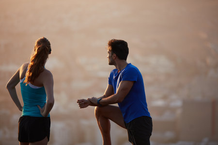 What a way to start the day. an athletic young couple out for a run in the morning.の写真素材