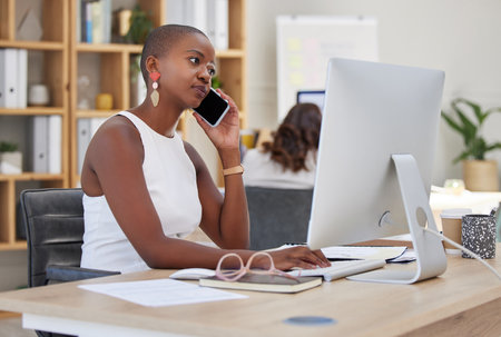 Work phone communication, working and web research of a black business woman multitasking. B2b and internet advertising strategy online planning of a digital marketing worker on a corporate callの写真素材