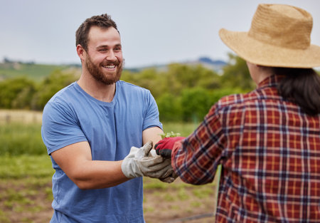 Sustainability farmer, agriculture plant and accountability growth mindset couple with on a farm, countryside field or nature. Happy man and woman with smile or eco environment garden farming workersの写真素材
