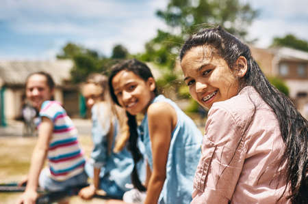 We rule the playground. Portrait of a group of happy schoolchildren playing together in the playground.の写真素材