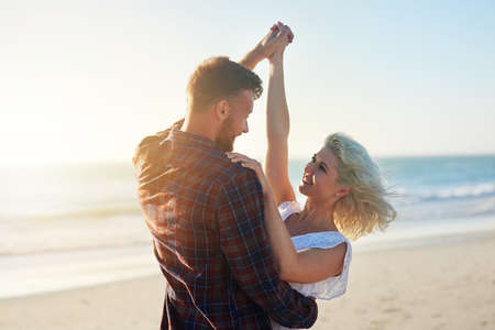 Were more in love than ever. an affectionate young couple enjoying their time on the beach.の写真素材