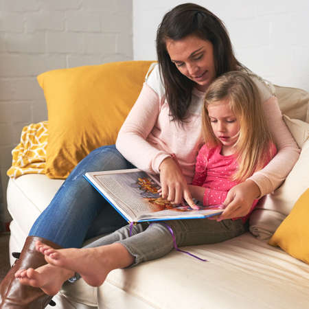 Every day is a good day for a story. a mother reading to her daughter.