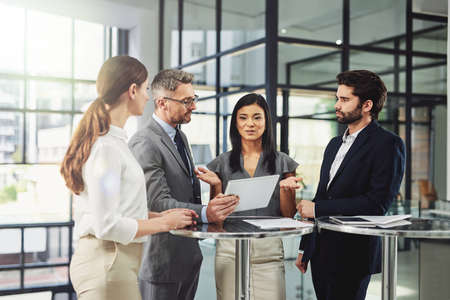 It all starts with a plan. a group of colleagues discussing business in the office.の写真素材