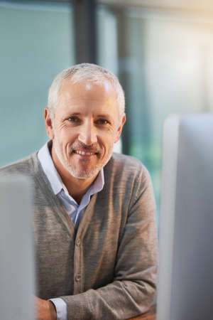 Confident in his career. Cropped portrait of a mature businessman sitting in his office.