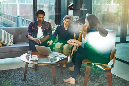Turning dreams into goals. a team of creative businesspeople brainstorming around a laptop in the...