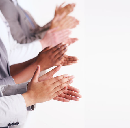 Well done. a group of people clapping their hands together.