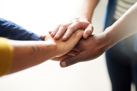 Joining together to get ahead. Closeup shot of a group of businesspeople joining their hands...