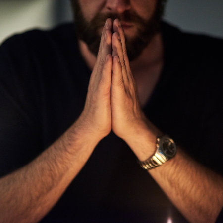 Praying hard for redemption. Closeup shot of a man with his hands clasped in prayer.の写真素材