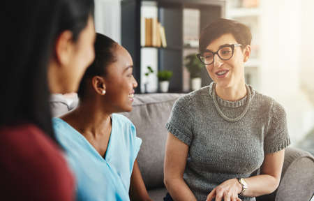 They enjoy spending time together while working. businesswomen having a conversation in the office.