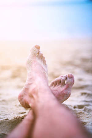 Relaxed on the beach. an unrecognizable womans feet at the beach.
