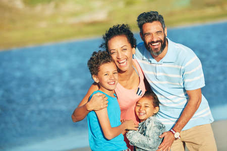 Oceans of fun. a family of four enjoying a day at the beach.