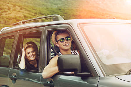Exploring the world together. Portrait of a young couple enjoying a roadtrip together.