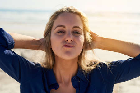 Shes a sucker for summer. Portrait of an attractive young woman enjoying a day outdoors.の写真素材