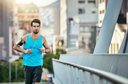 Working up a sweat. a handsome young man working out in the city.