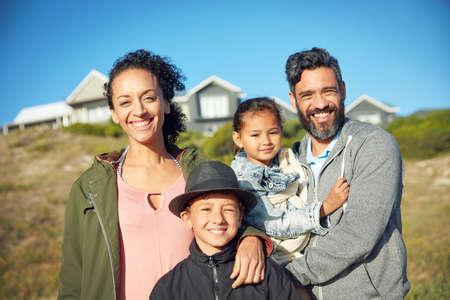 The happiest moments in life are spend with family. a family of four spending the day outdoors.