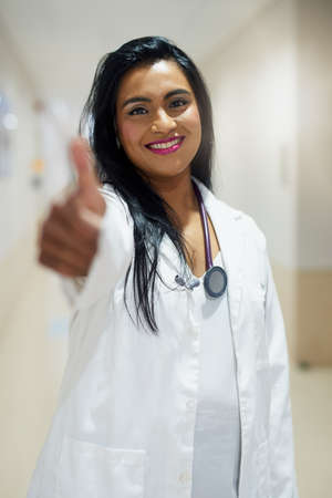 Your health status is looking positive. Portrait of a doctor showing thumbs up in a hospital.の写真素材