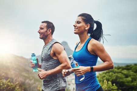 Our relationship goals is getting fit. a young attractive couple training for a marathon outdoors.