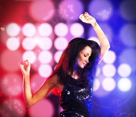 Sexy woman dancing in disco or club party with color light in background with energy to dj music....