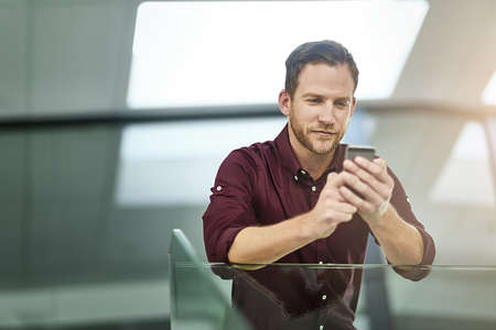 Technology can help you reach customers where theyre at, online. a businessman using his cellphone...
