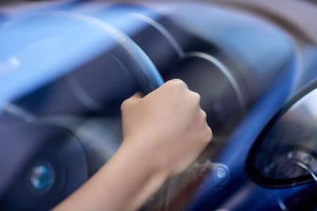 Hold on tight. hands holding onto a steering wheel while driving.の写真素材