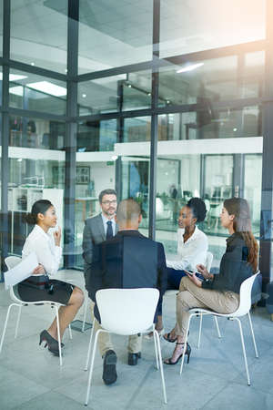 Their diverse thinking is their greatest asset. a diverse group of businesspeople having a meeting in the boardroom.の写真素材